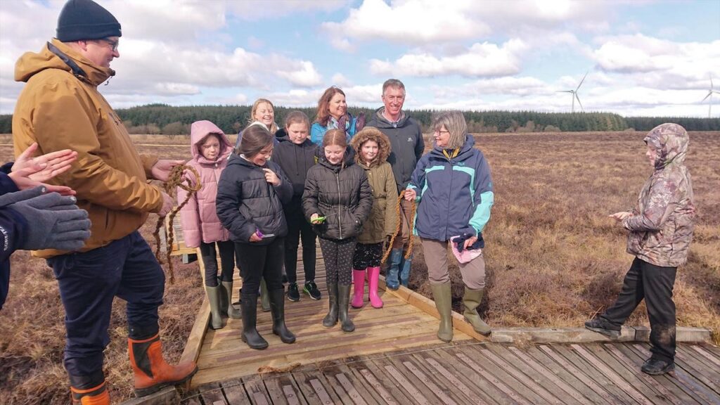 Photo of the opening of new boardwalk – pupils from the local primary school with Rob Forrest CEO, GreenPower and Adrian Warman, Head of Operation, Thrive Renewables with Amee Hood, NNR Reserve Manager and Heather Reid, Board Member, NatureScot.